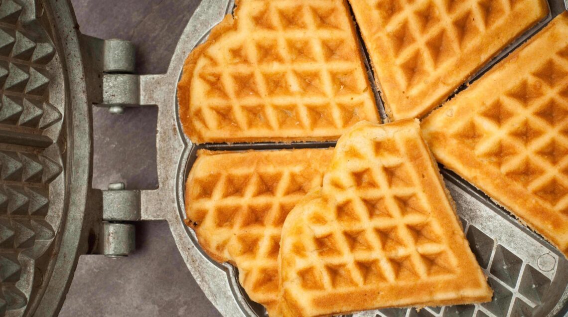 Swedish heart shaped waffles served in a traditional cast iron waffle pan.