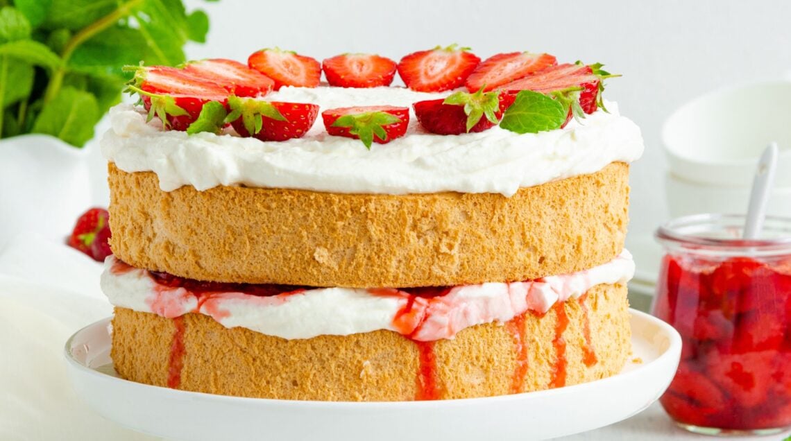 Victoria sponge cake with strawberry jam, whipped cream and fresh strawberries