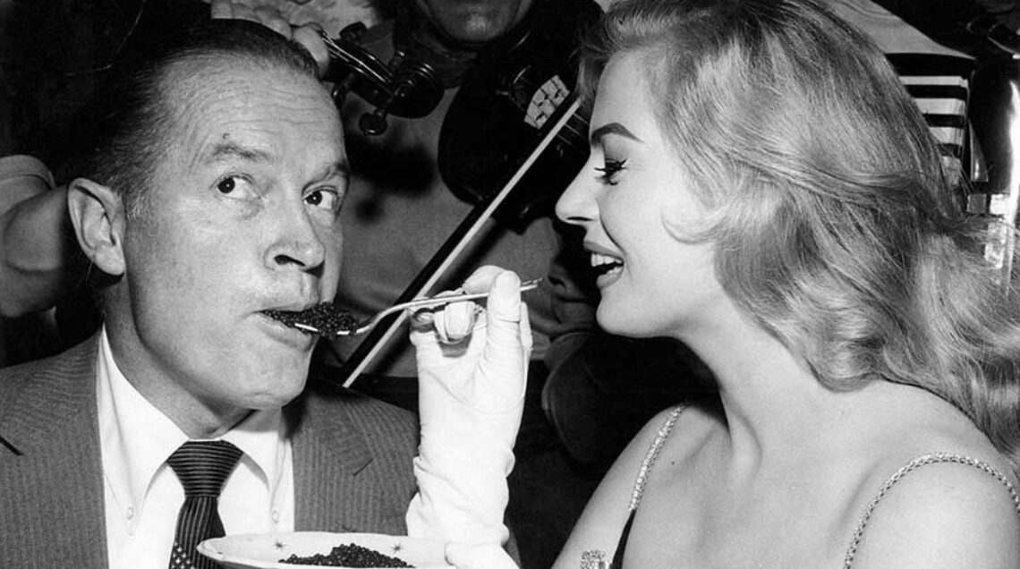 Anita Ekberg feeding Bob Hope caviar 1962