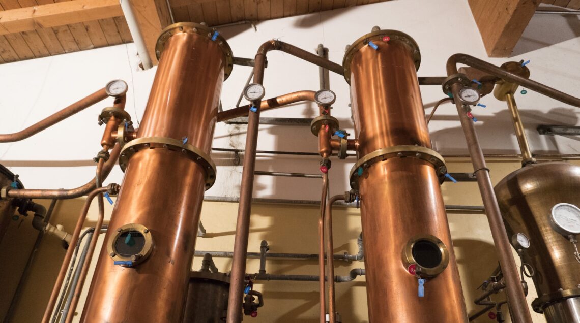 Copper still alembic inside distillery