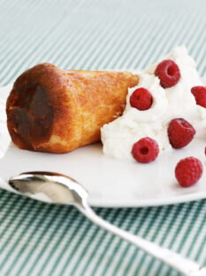 Babà al rum con panna e lamponi