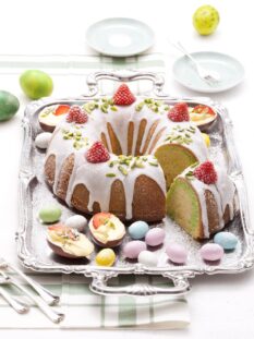 Ciambella con glassa bianca guarnita con fragole e ovetti di cioccolato