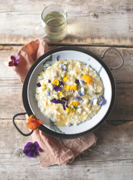 piatto di risotto al formaggio con miele e fiuodi eduli
