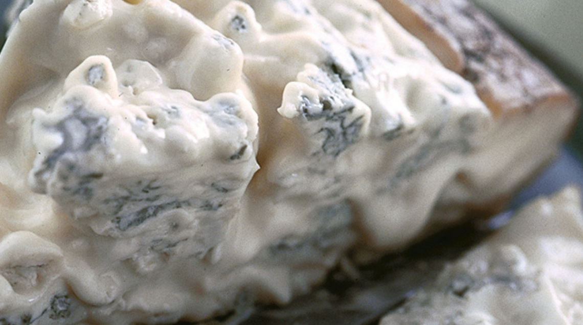 Una grande fetta morbida e gustosa di Gorgonzola, su un tagliere