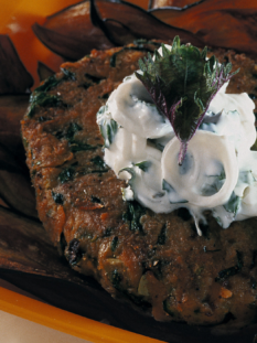 Hamburger vegetariano con salsa di yogurt, in un piatto quadrato e arancione