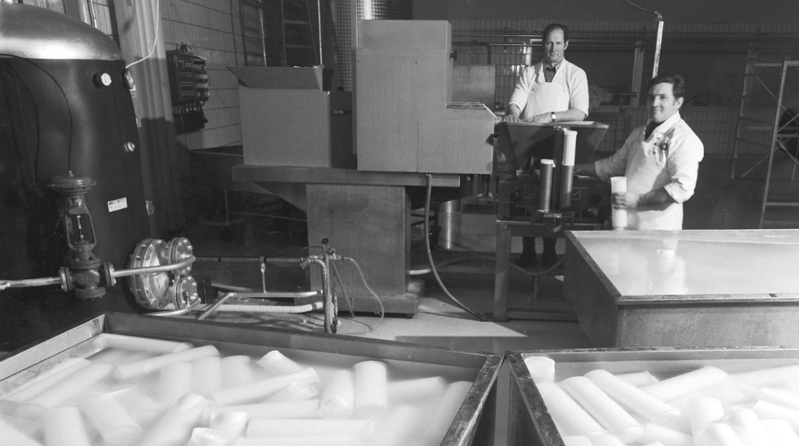 Foto d'epoca in bianco e nero di due casari in un laboratorio di produzione mozzarelle.