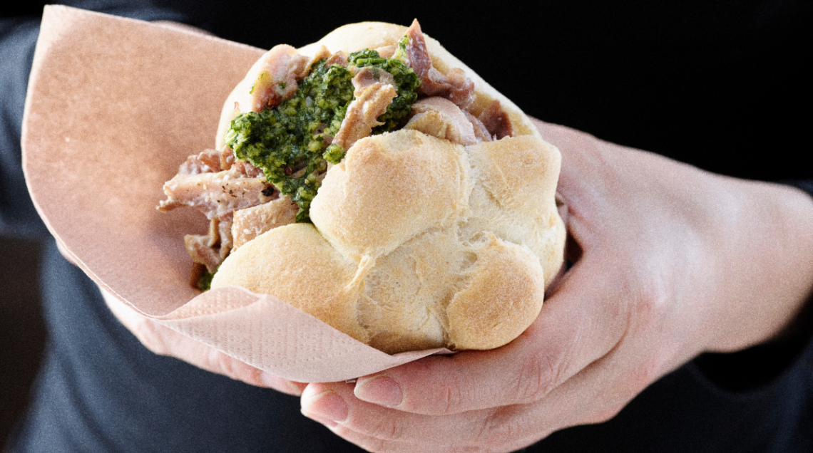 Panino con il lampredotto tenuto in mano
